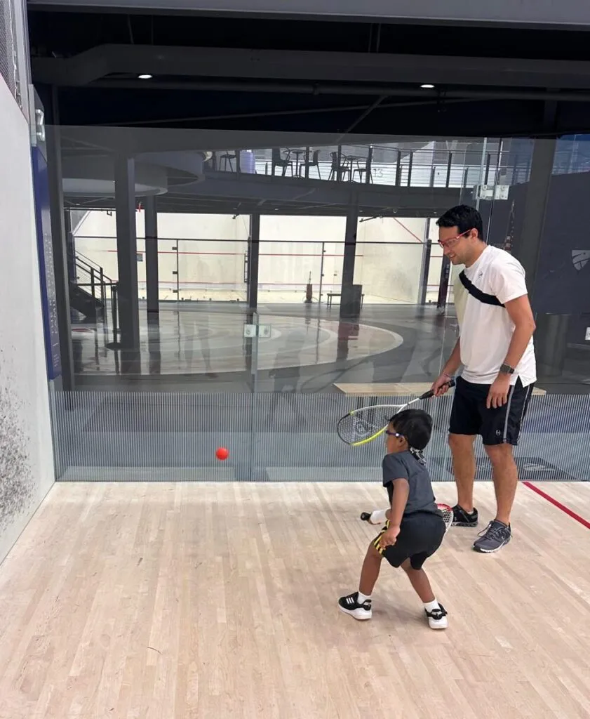 A junior player receiving individual coaching on court